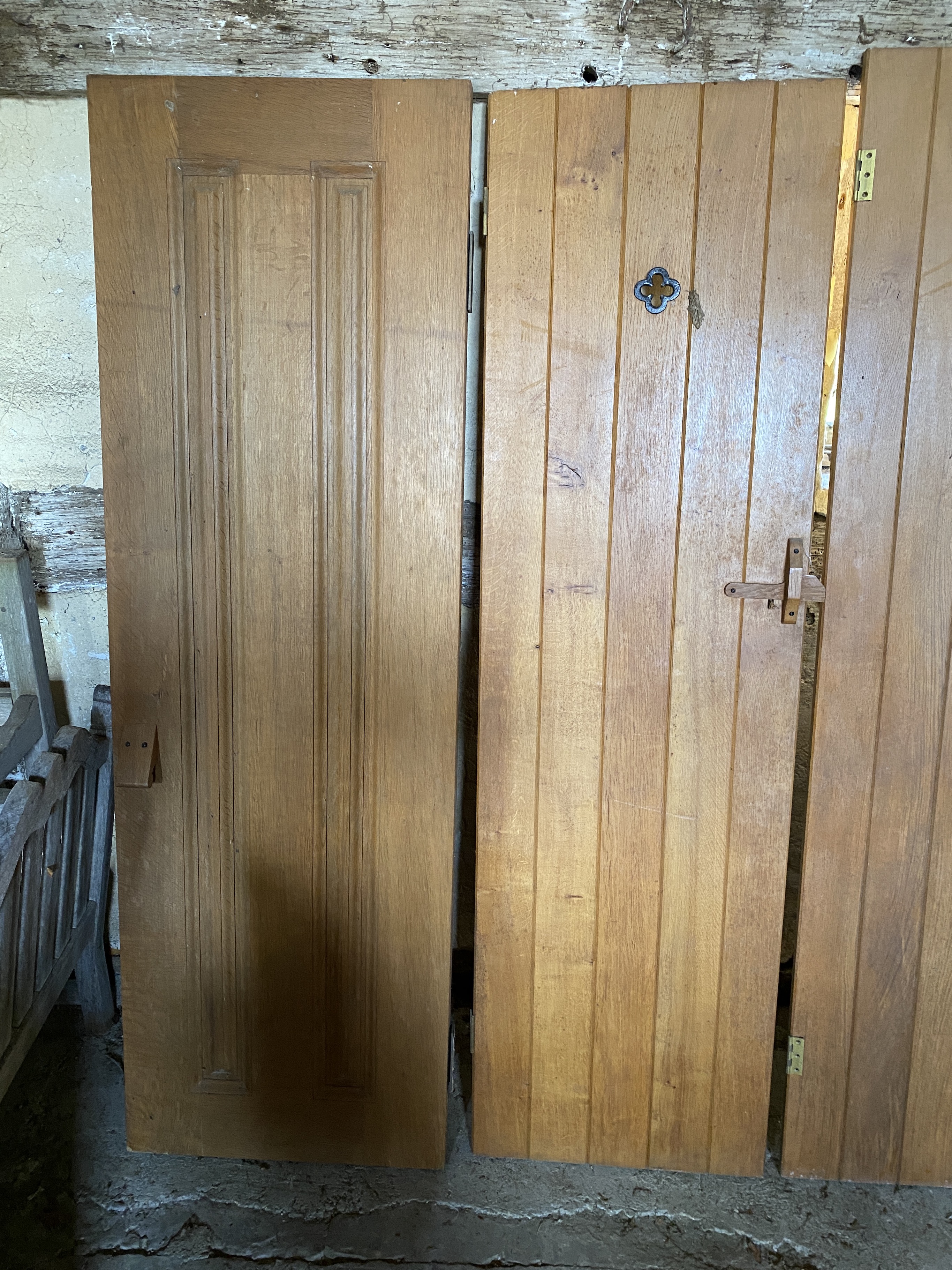 Three solid oak ledged and braced doors, 210 x 58.5cm; 204 x 44.5cm and 95 x 72cm, and a double sided panelled solid oak door, 200 x 64cm (4)